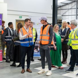 Andy Murray in warehouse in conversation with a group of people
