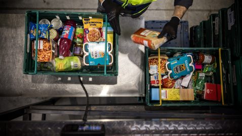 Top down photo of person filling crates with food