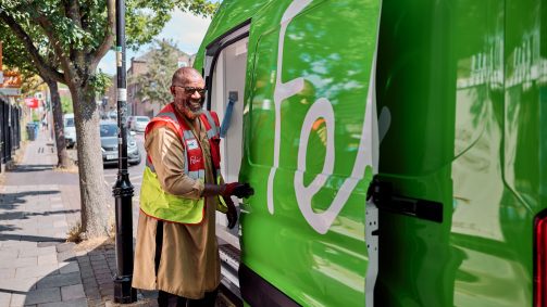 Man in high-vis closing door of green Felix van