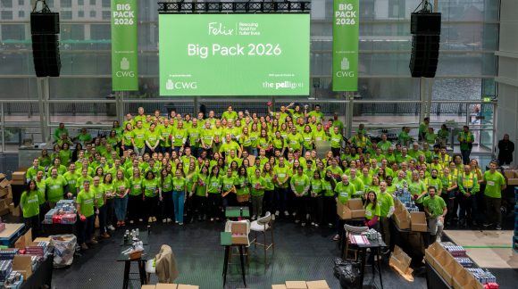 A room full of 200+ volunteers posing for a photograph
