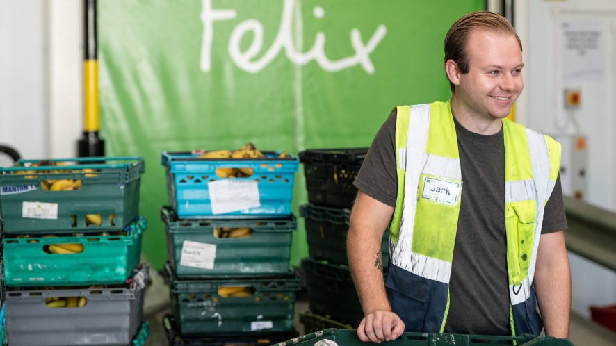 Man in high-vis smiling in front of Felix door