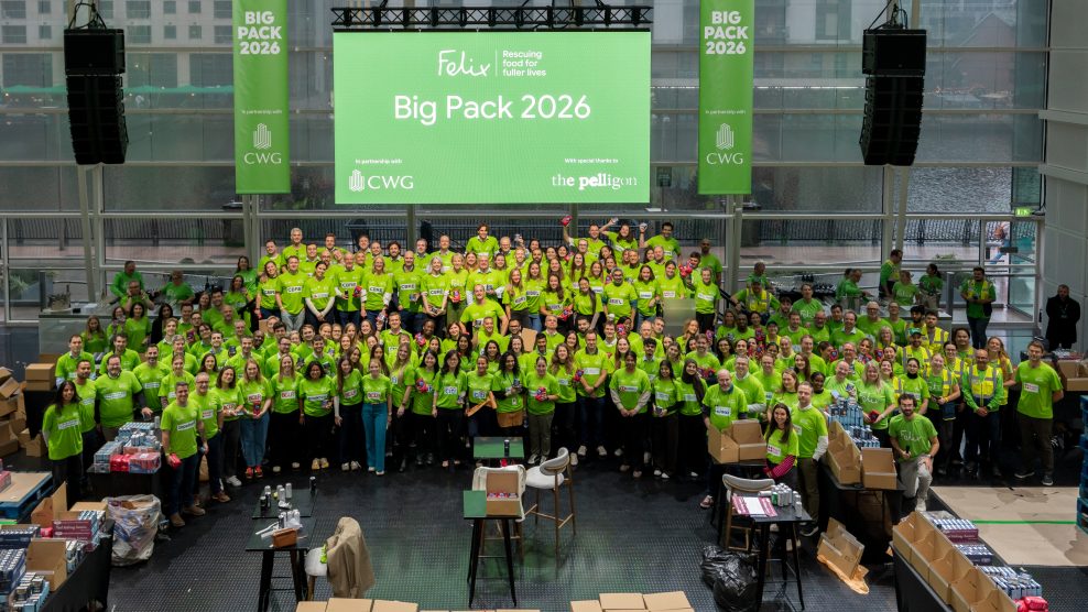A room full of 200+ volunteers posing for a photograph