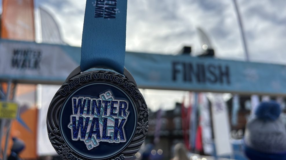 Winter walk medal in front of the finish line